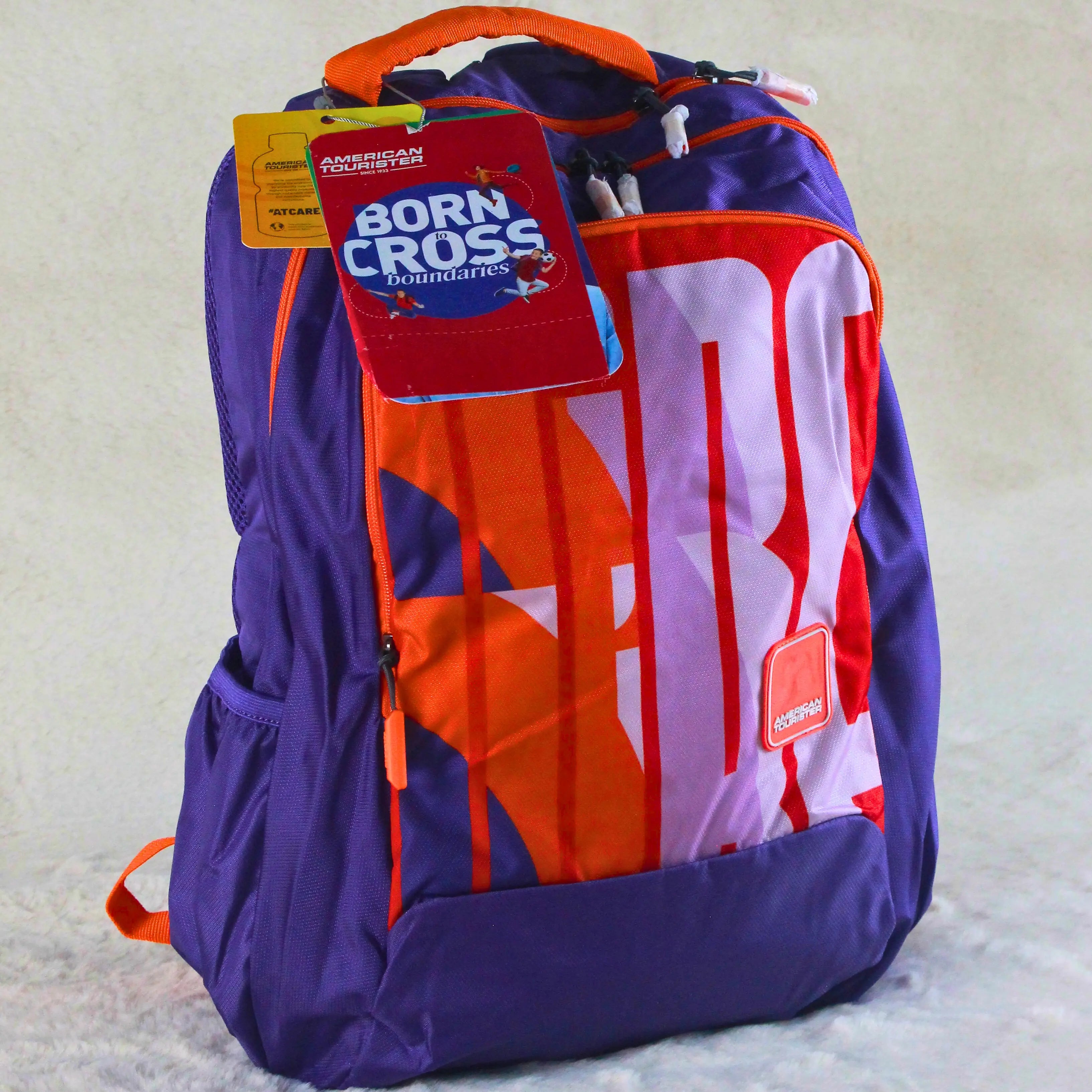 American Tourister Bold Purple & Orange Graphic Backpack – Spacious, Stylish & Travel Friendly – Imported